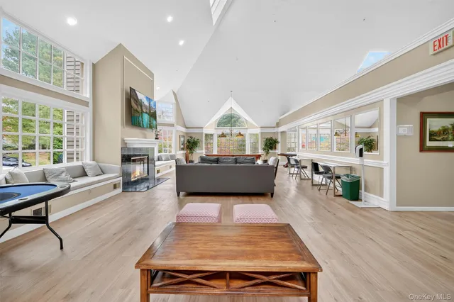 a living room with furniture a large window with kitchen view