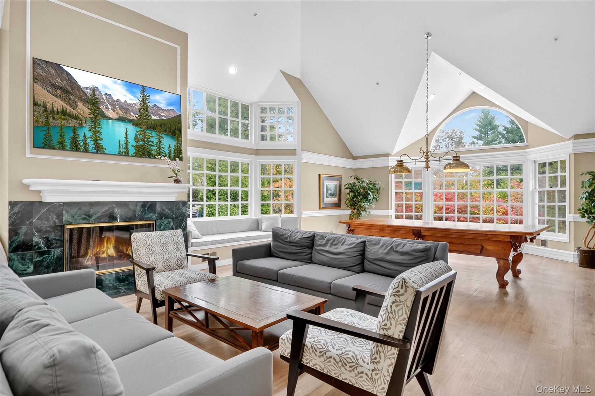 57 Boulder Ridge Road Scarsdale, NY 10583 - Photo 42 of 49 a living room with furniture a flat screen tv and a large window