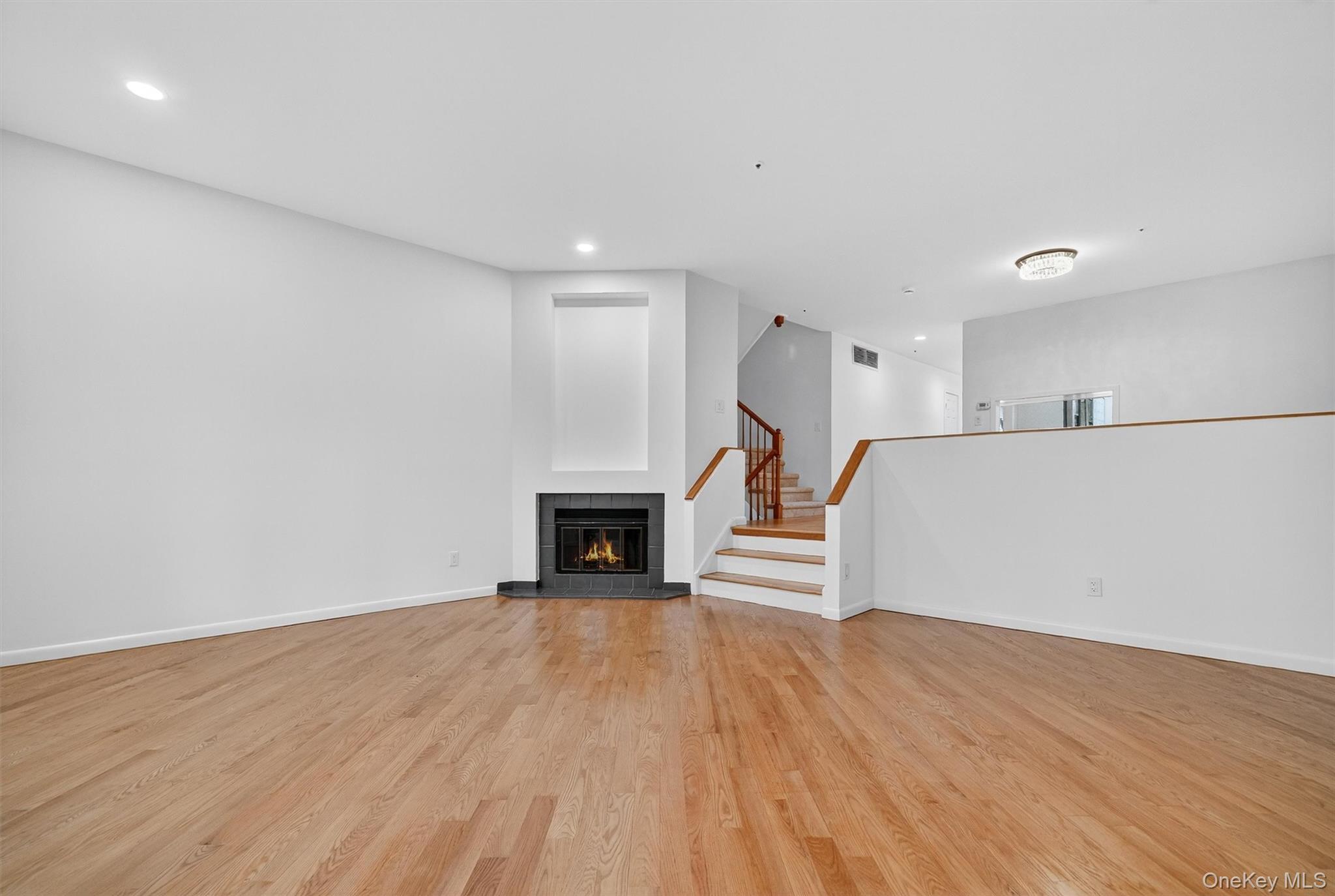 57 Boulder Ridge Road Scarsdale, NY 10583 - Photo 10 of 49 a view of a livingroom with wooden floor and a fireplace
