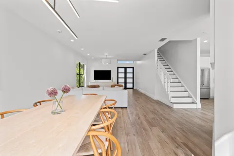 a kitchen with a sink and wooden floor