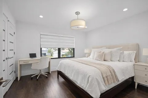 a bathroom with a double vanity sink toilet mirror and bathtub