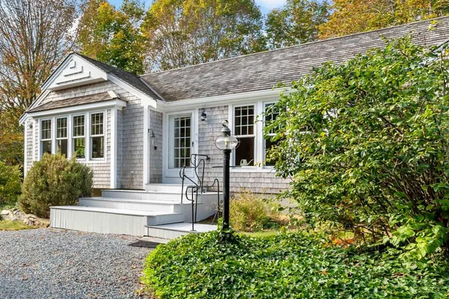 a front view of a house with garden