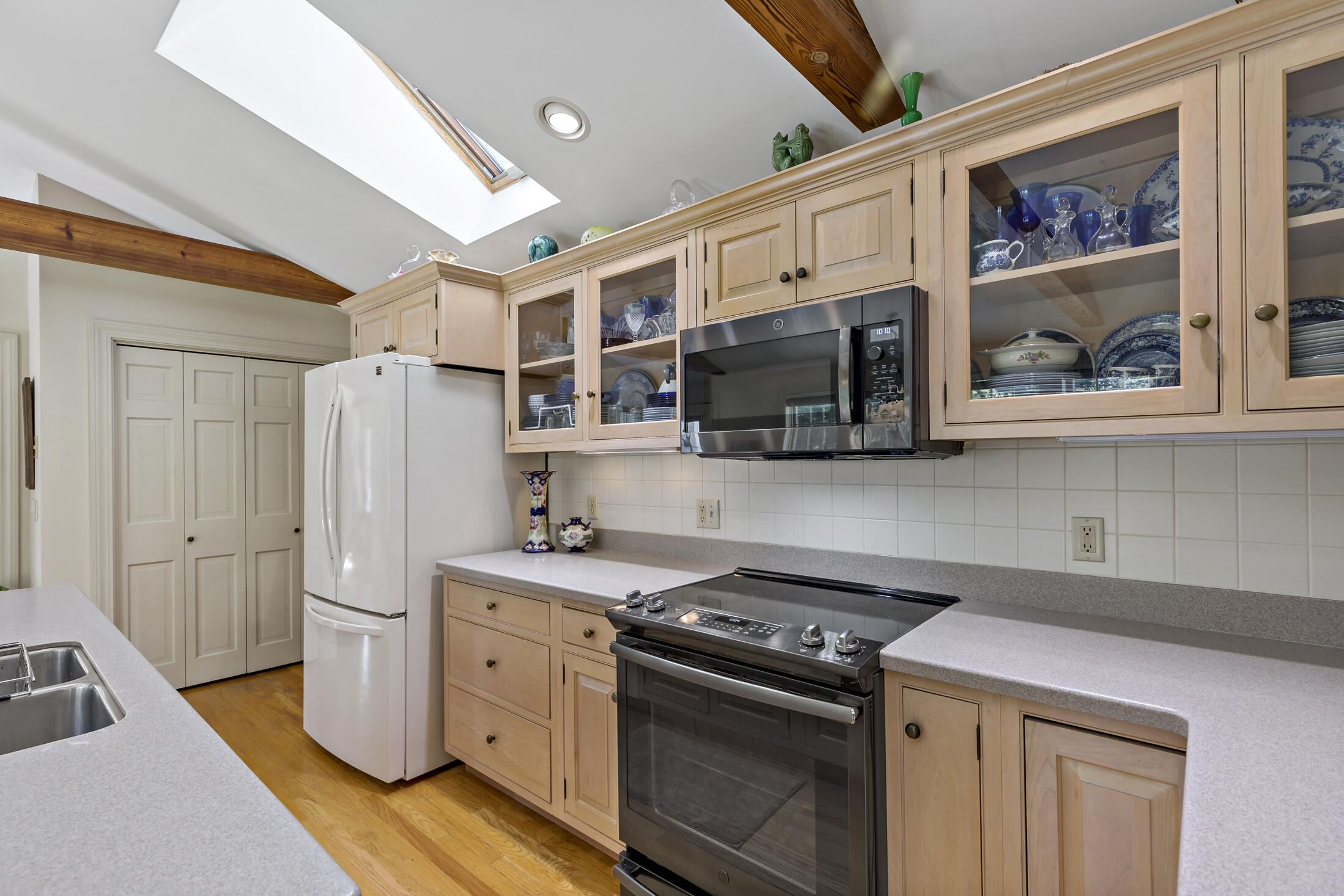 645 Samoset Road Eastham, MA 02642 - Photo 7 of 49 a kitchen with stainless steel appliances a stove a refrigerator and cabinets