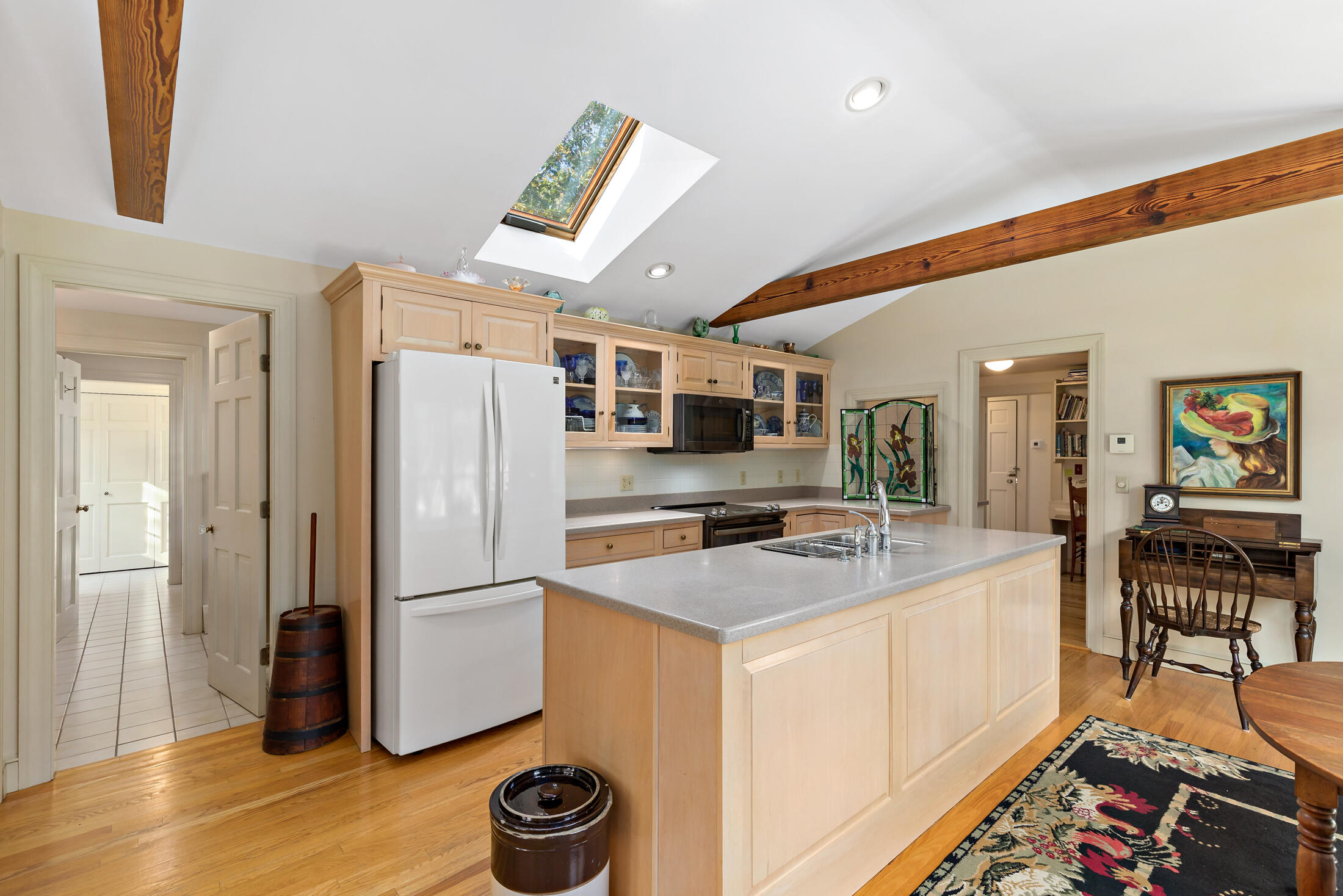 645 Samoset Road Eastham, MA 02642 - Photo 10 of 49 a kitchen with a refrigerator a stove and a dining table with wooden floor