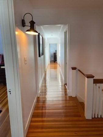 1 Surfside Road Scituate, MA 02066 - Photo 21 of 32 a view of a hallway with wooden floor and staircase