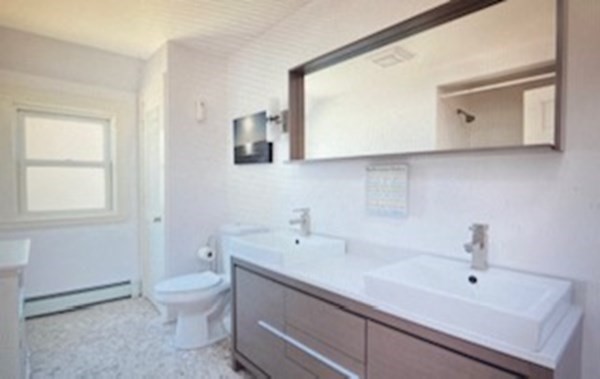 1 Surfside Road Scituate, MA 02066 - Photo 29 of 32 a bathroom with a sink and a mirror