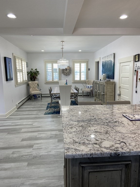1 Surfside Road Scituate, MA 02066 - Photo 8 of 32 a living room with kitchen island granite countertop furniture and fireplace