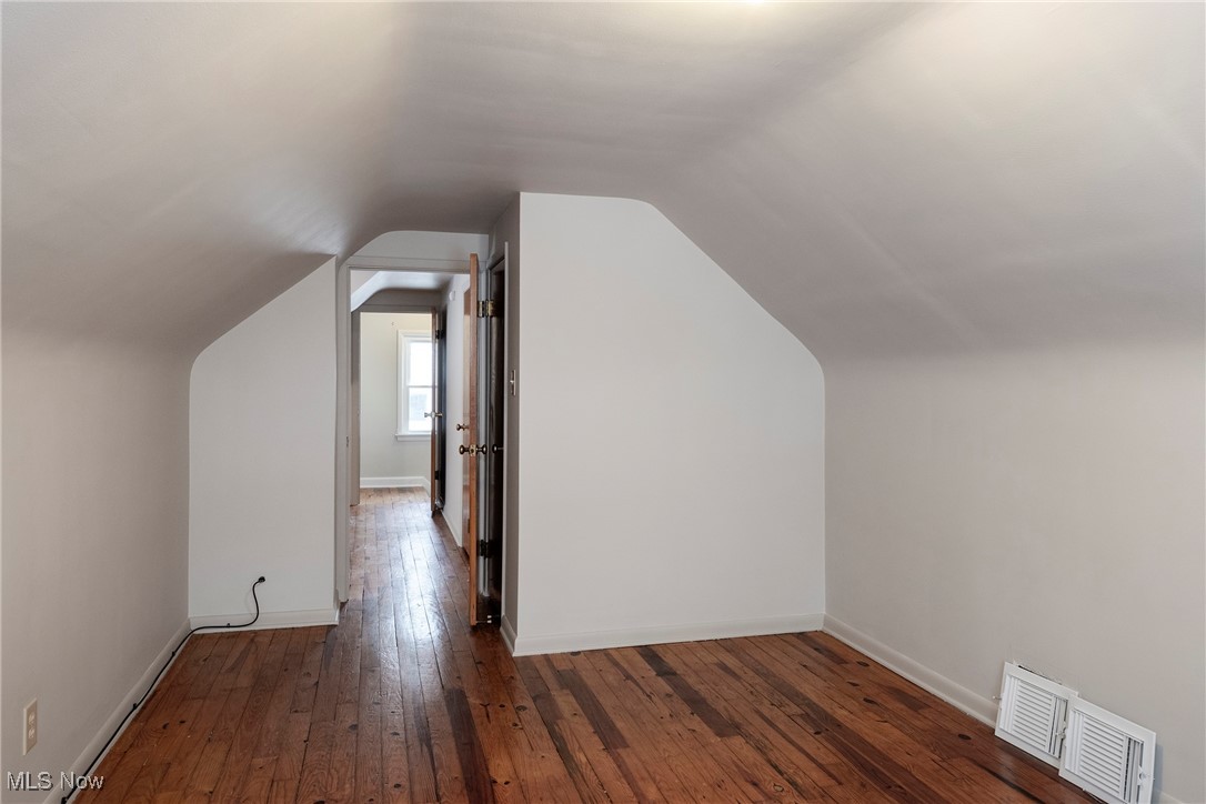 767 Glenhurst Road Willowick, OH 44095 - Photo 24 of 42 Bonus room with dark hardwood / wood-style floors and vaulted ceiling