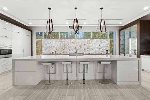 a kitchen with a sink and wooden floor