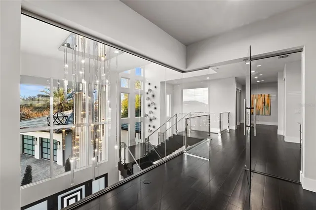 a view of a hallway with wooden floor and livingroom view