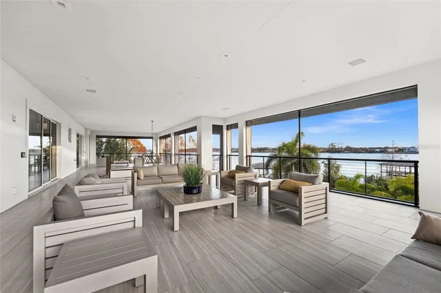 a living room with furniture and a floor to ceiling window