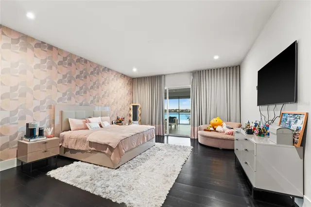 a bedroom with a bed and flat screen tv