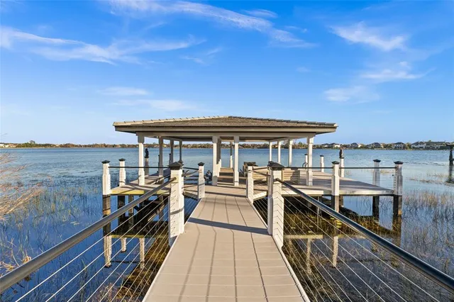 a view of a balcony with wooden floor and iron stairs