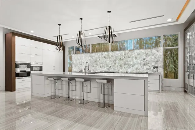 a view of living room with stainless steel appliances granite countertop furniture and a wooden floor