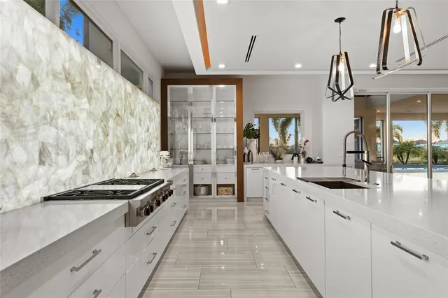 a large kitchen with granite countertop a sink and cabinets