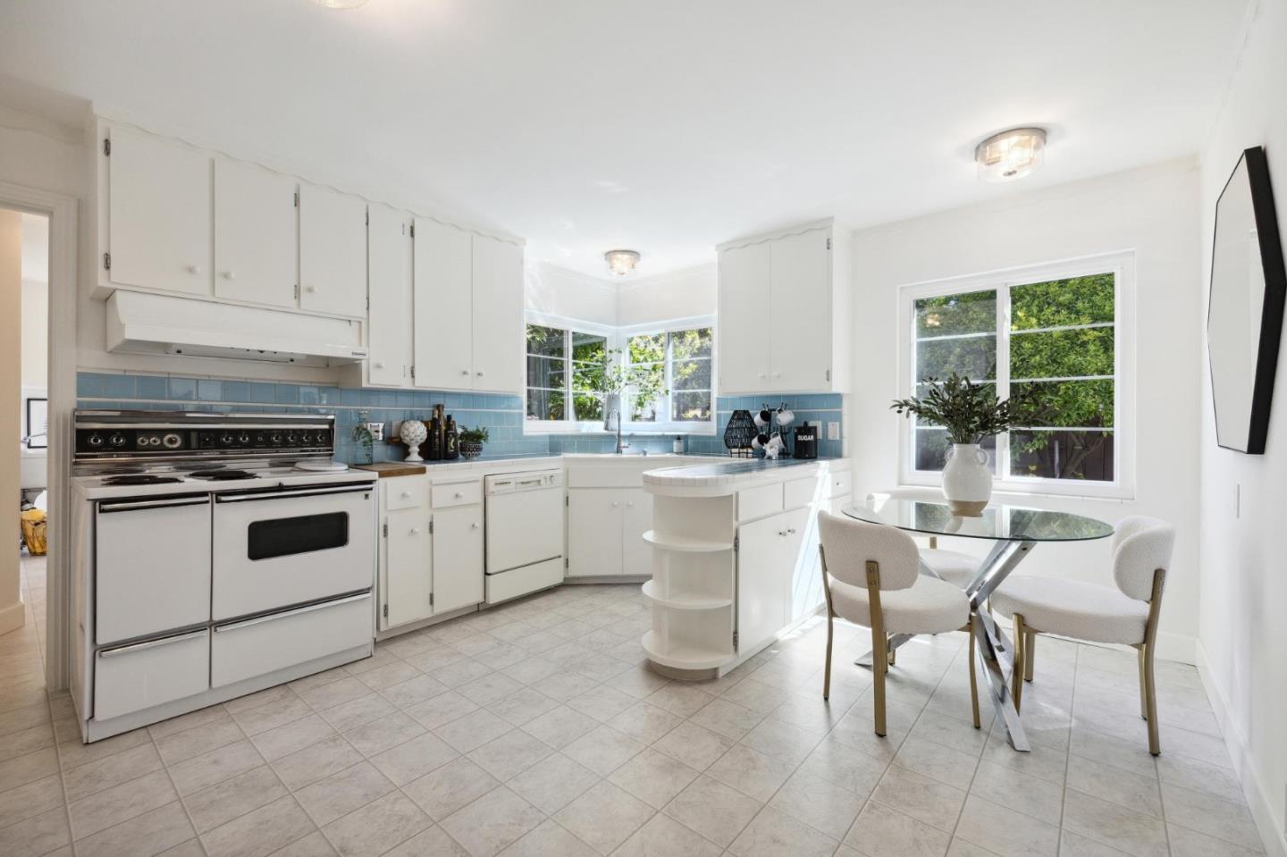 595 Anza Street Mountain View, CA 94041 - Photo 21 of 72 a kitchen with white cabinets and white appliances