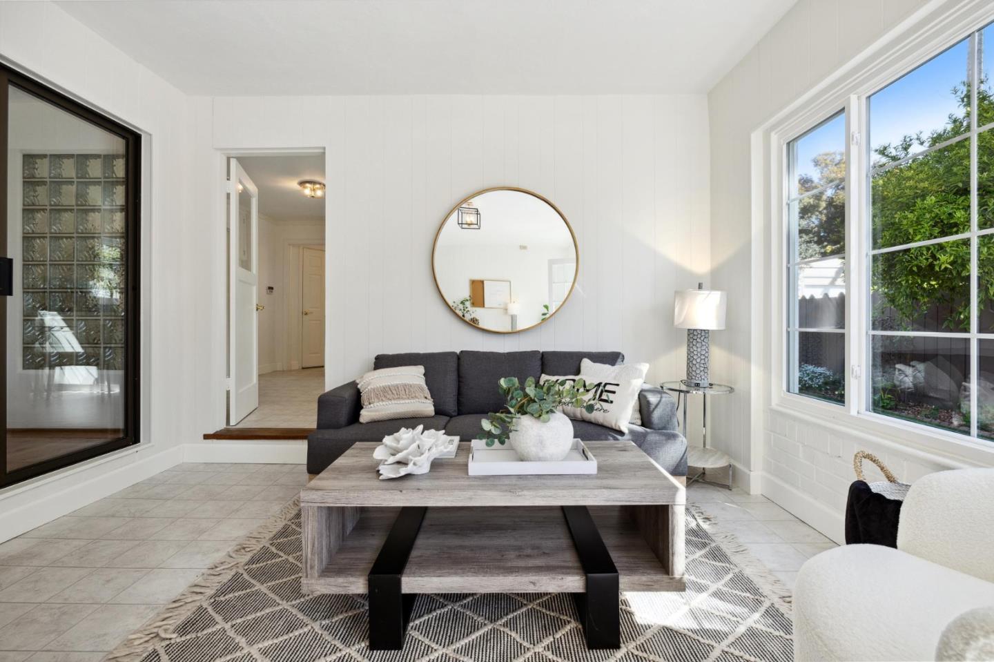 595 Anza Street Mountain View, CA 94041 - Photo 30 of 72 a living room with furniture a rug potted plant and a large window