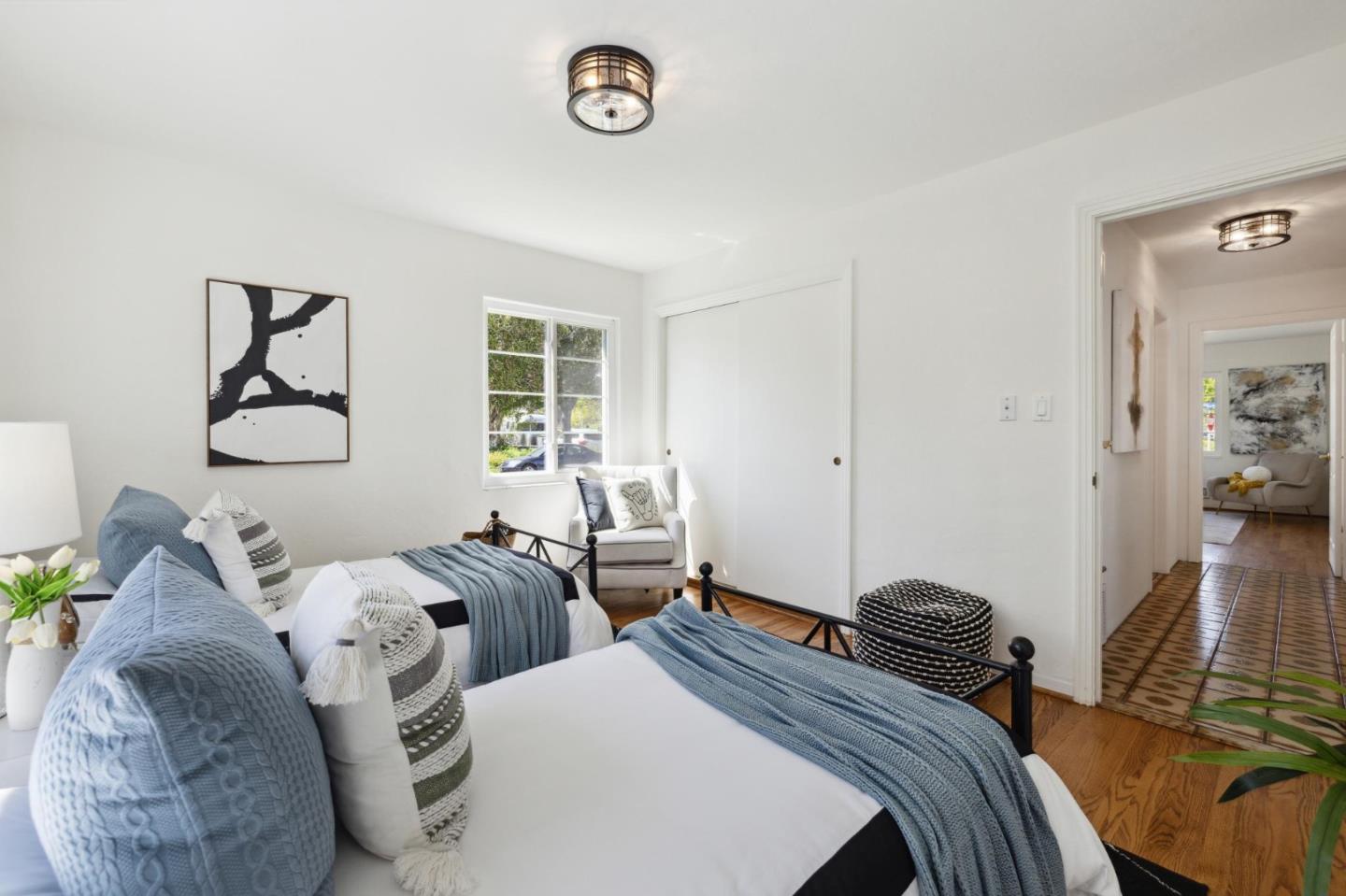 595 Anza Street Mountain View, CA 94041 - Photo 45 of 72 a bedroom with two beds and a chandelier