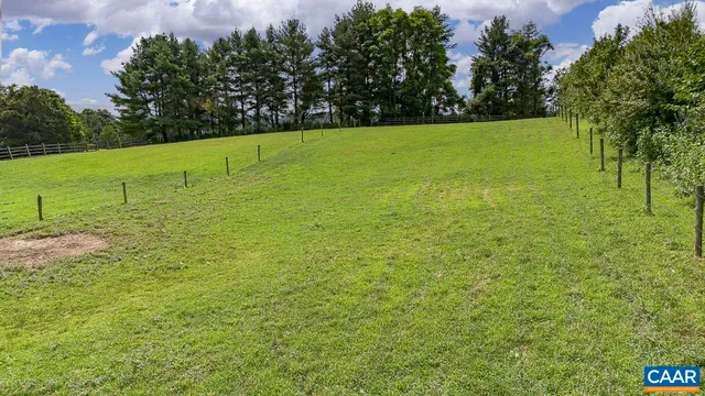 a view of a backyard with side of the road