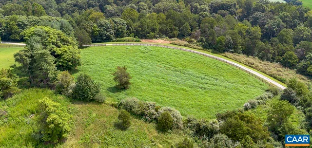an outdoor sitting area with chairs and umbrella