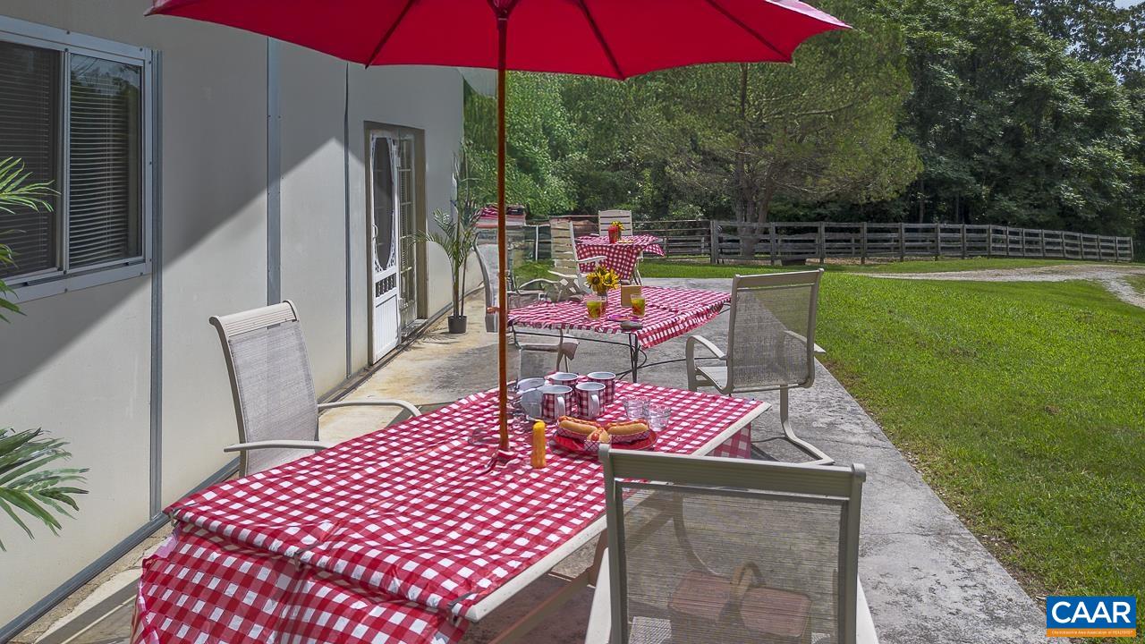 9195 Springwood Road Buchanan, VA 24066 - Photo 27 of 75 an outdoor sitting area with chairs and umbrella