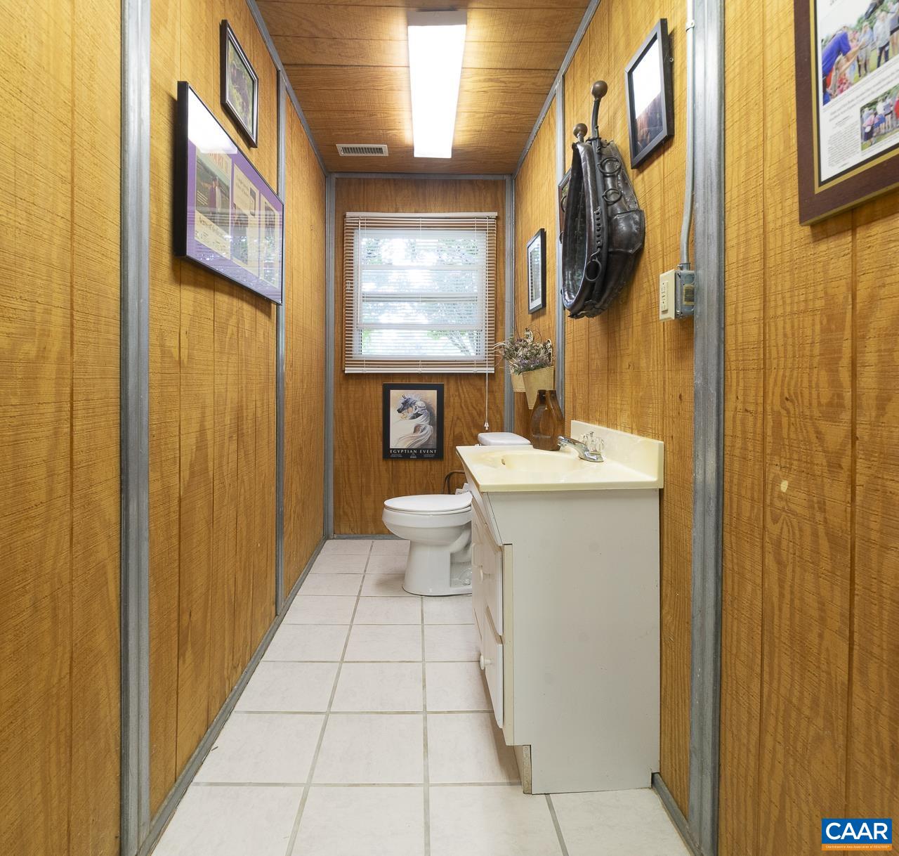 9195 Springwood Road Buchanan, VA 24066 - Photo 51 of 75 a bathroom with a toilet sink and mirror