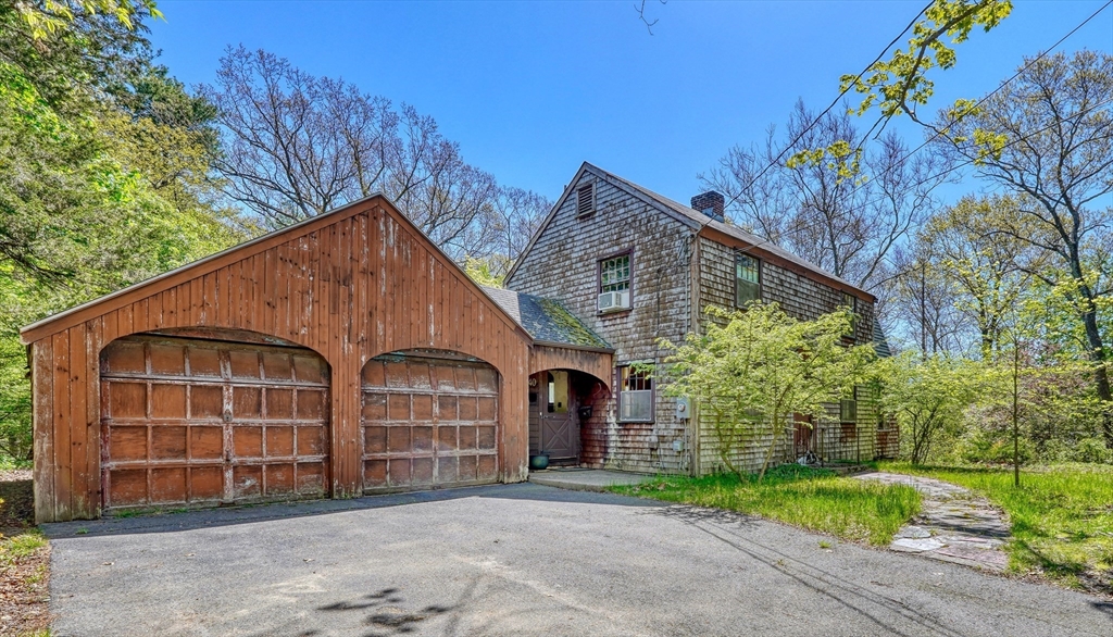 40 Lancaster Drive Westwood, MA 02090 - Photo 2 of 29 a view of a house with large windows and a small yard