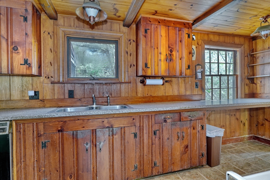 40 Lancaster Drive Westwood, MA 02090 - Photo 8 of 29 a kitchen with wooden cabinets a sink and a window