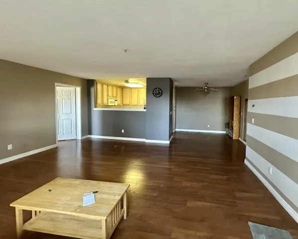 a view of a livingroom with wooden floor and window
