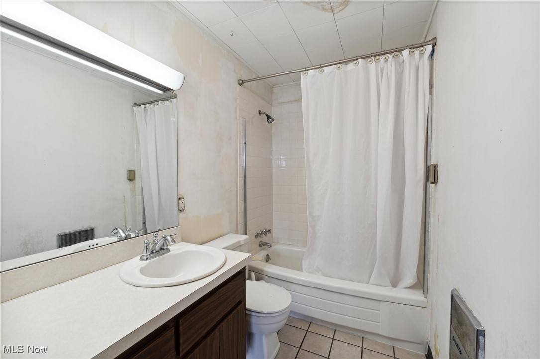 86413 North Bay Road Scio, OH 43988 - Photo 26 of 45 Full bathroom featuring vanity, tile patterned flooring, shower / bathtub combination with curtain, and toilet