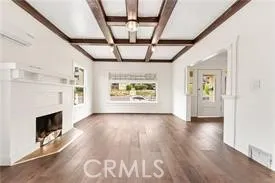 a view of an empty room with exposed radiator and fireplace