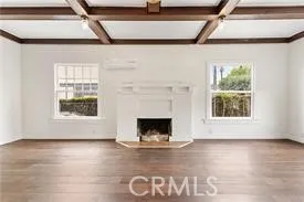 a view of wooden floor a fireplace and a window
