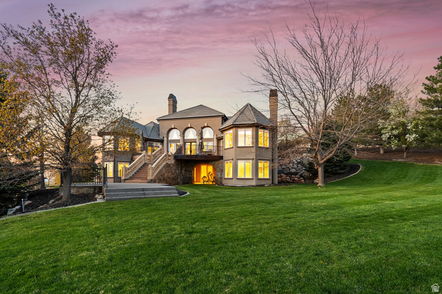 1714 Ridge Point Drive Bountiful, UT 84010 - Photo 131 of 132 Expansive green lawn surrounds a multi-level stucco exterior with arched windows, a private balcony, and stone staircase