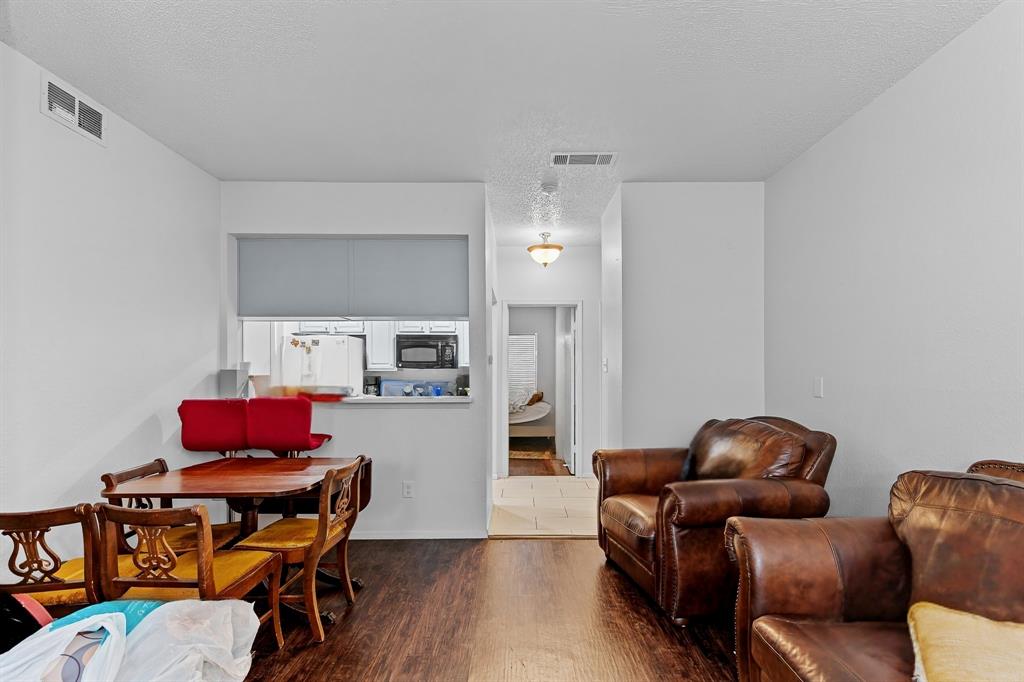 806 West 24th Street, Unit 214 Austin, TX 78705 - Photo 11 of 30 a living room with furniture and a wooden floor