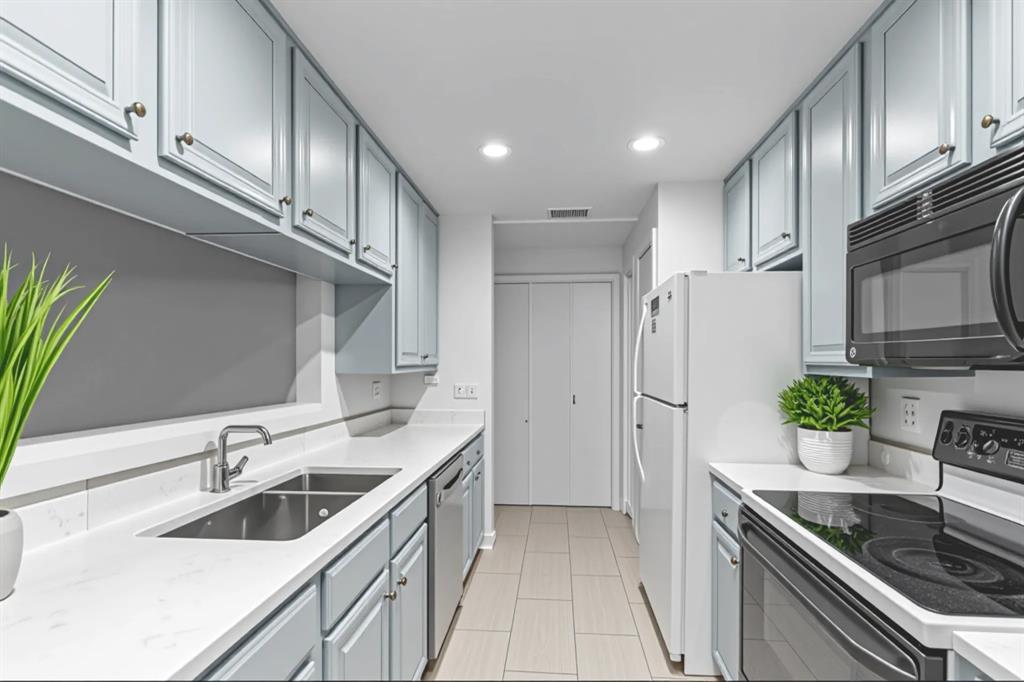 806 West 24th Street, Unit 214 Austin, TX 78705 - Photo 13 of 30 a kitchen that has a sink cabinets counter space and stainless steel appliances