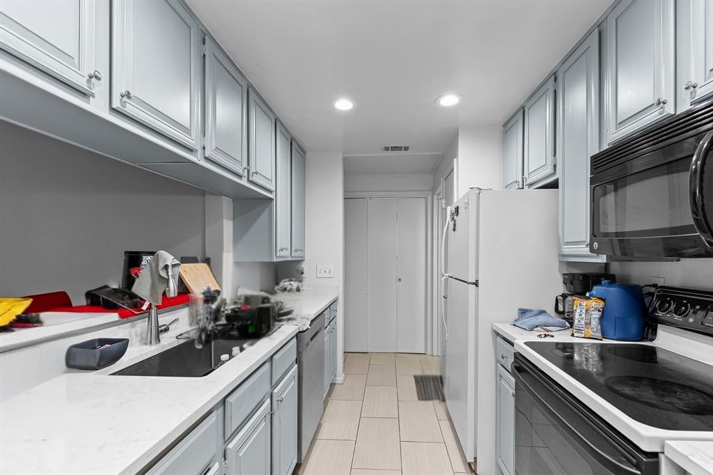 806 West 24th Street, Unit 214 Austin, TX 78705 - Photo 14 of 30 a kitchen with stainless steel appliances a sink stove and cabinets