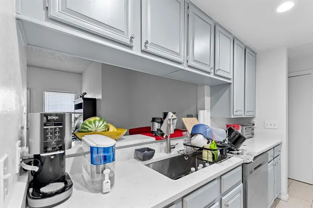 a kitchen with stainless steel appliances a stove a microwave and a refrigerator