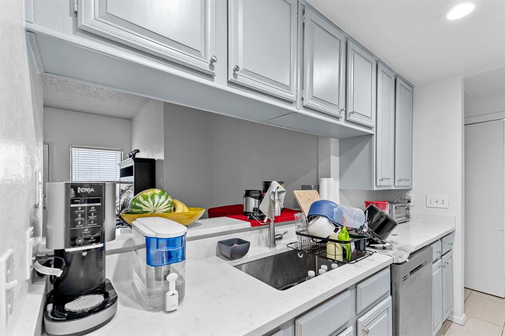806 West 24th Street, Unit 214 Austin, TX 78705 - Photo 15 of 30 a kitchen with white cabinets and appliances