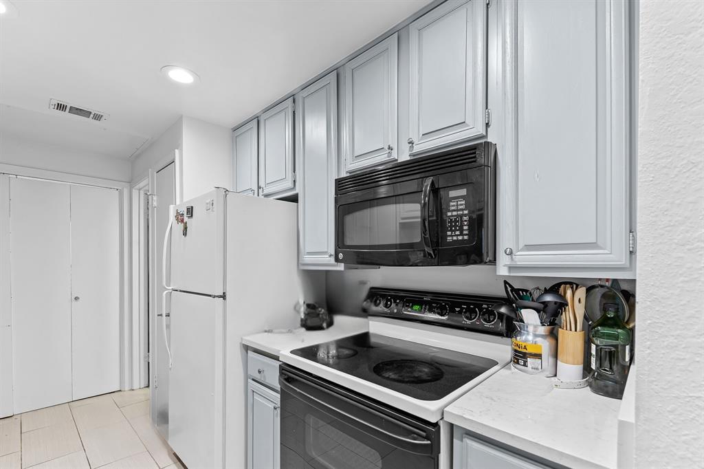 806 West 24th Street, Unit 214 Austin, TX 78705 - Photo 16 of 30 a kitchen with stainless steel appliances a stove a microwave and a refrigerator
