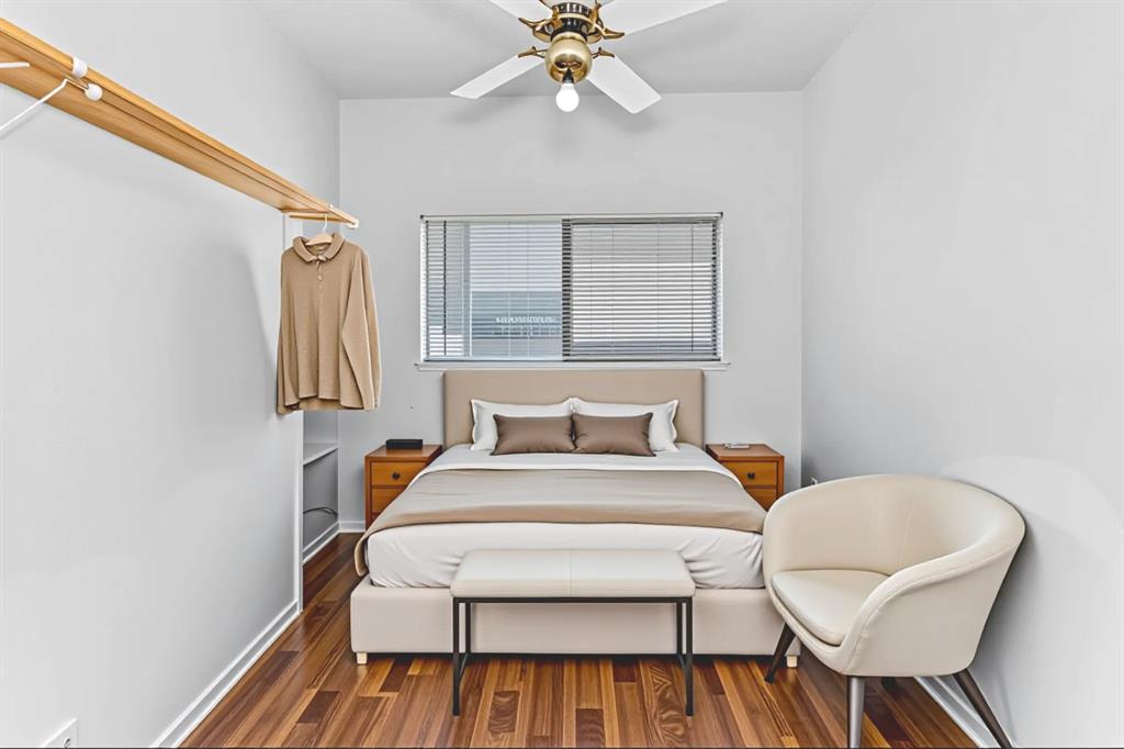 806 West 24th Street, Unit 214 Austin, TX 78705 - Photo 25 of 30 a bedroom with a bed and a chandelier