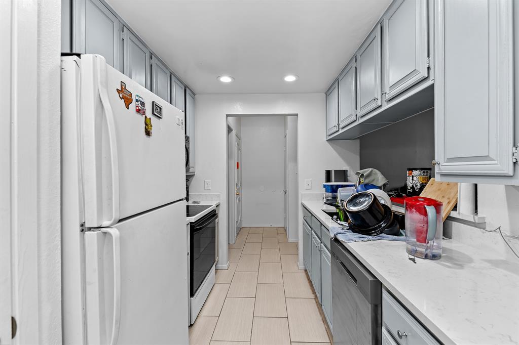 806 West 24th Street, Unit 214 Austin, TX 78705 - Photo 26 of 30 a kitchen with a sink a refrigerator and cabinets