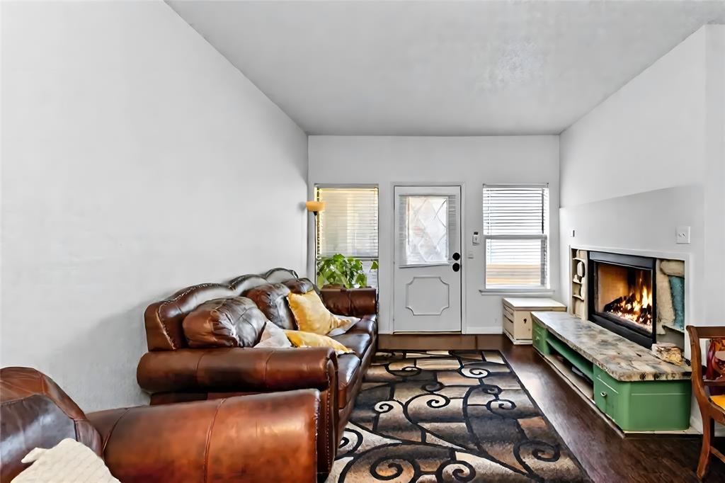 806 West 24th Street, Unit 214 Austin, TX 78705 - Photo 7 of 30 a living room with furniture and a fireplace