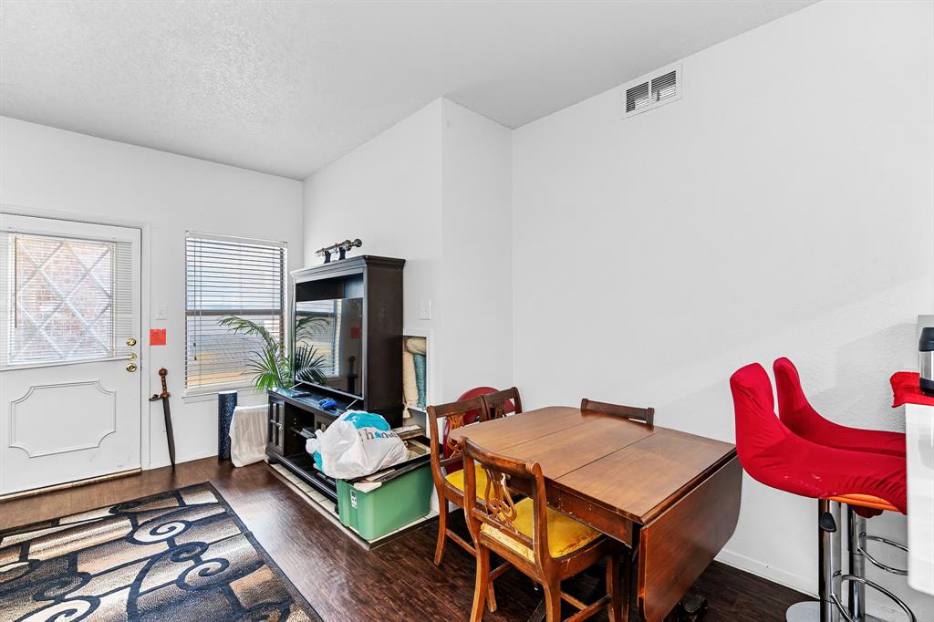 806 West 24th Street, Unit 214 Austin, TX 78705 - Photo 9 of 30 a living room with furniture a flat screen tv and a table
