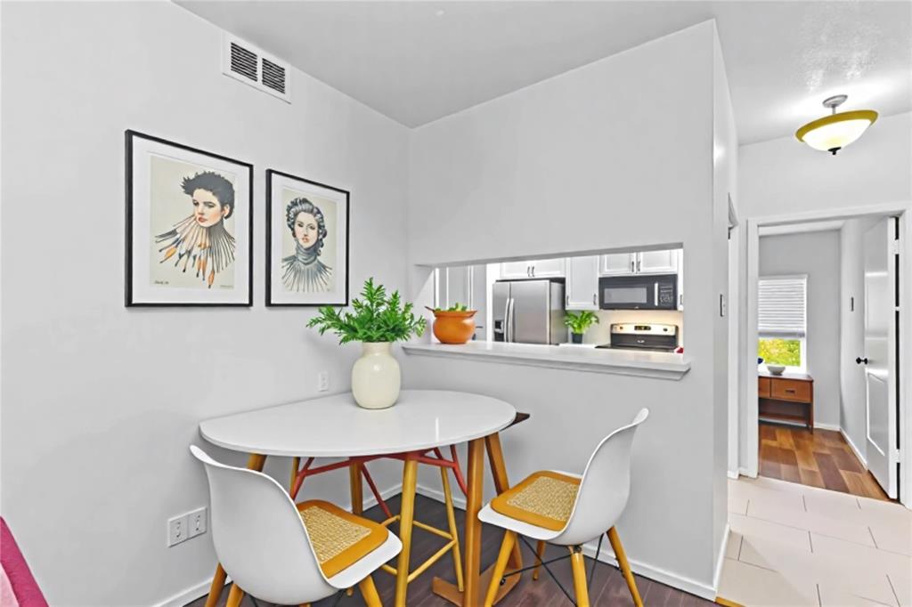 806 West 24th Street, Unit 214 Austin, TX 78705 - Photo 10 of 30 a dining room with furniture and painting on the wall