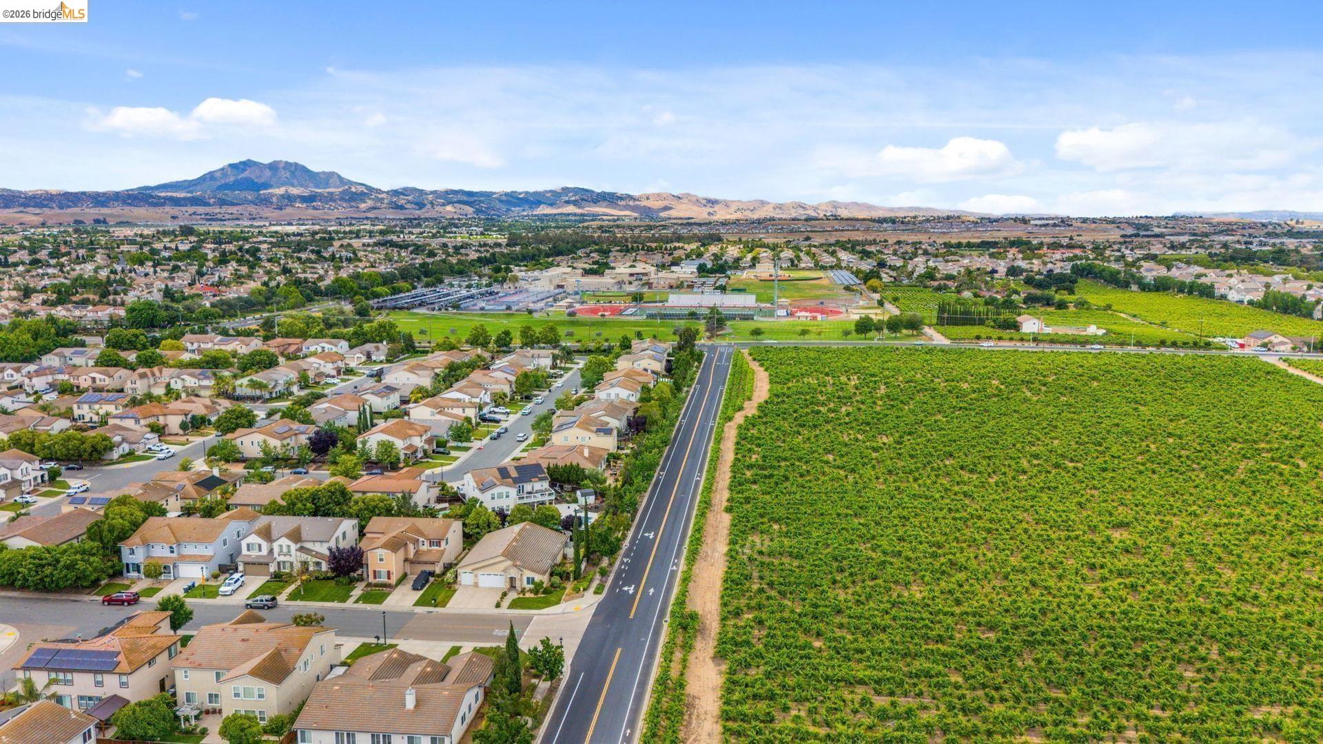 700 Brownstone Road Oakley, CA 94561 - Photo 4 of 58 Expansive aerial perspective showcasing a residential development bordering agricultural land