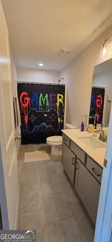 a spacious bathroom with a double vanity sink and a large mirror
