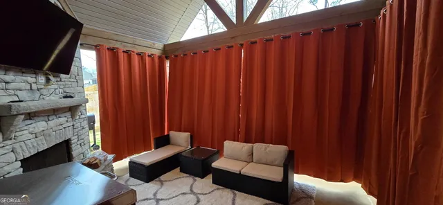 a outdoor living space with furniture and a fireplace