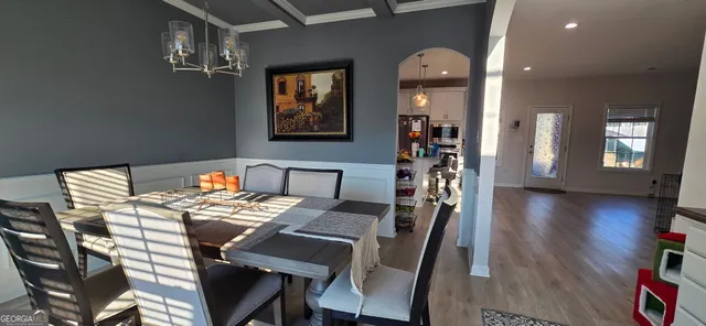 a view of a dining room with furniture and wooden floor