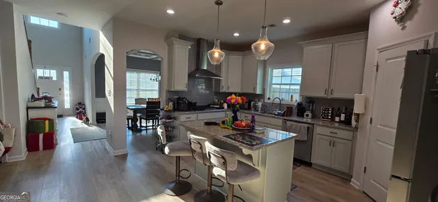 a kitchen with sink stove and wooden floor