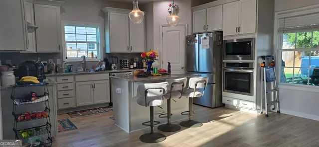 a view of a kitchen with fridge and window